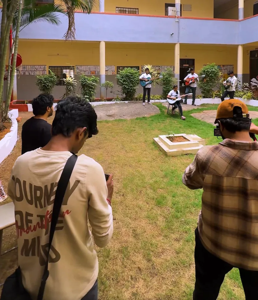 SpaceKey crew filming a school performance in a campus courtyard